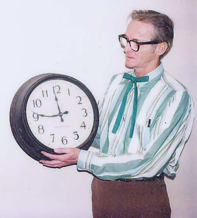 Bill Lipscomb (William Lipscomb)
          holding the clock with the bent minute hand